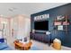 Stylish living area with a large TV, shelving with games, and comfortable blue seating at 841 Steel Dr, Apollo Beach, FL 33572
