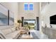 A soaring, bright living room featuring neutral decor, comfortable seating, and backyard views at 841 Steel Dr, Apollo Beach, FL 33572