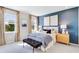 A soothing bedroom with a blue accent wall, two windows, and soft carpet at 841 Steel Dr, Apollo Beach, FL 33572