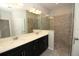 Modern bathroom features double vanity, large mirror and glass enclosed tiled shower with bench at 843 Steel Dr, Apollo Beach, FL 33572