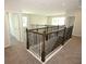 Upstairs hallway with carpet flooring, wood and iron balustrade staircase and neutral paint color at 843 Steel Dr, Apollo Beach, FL 33572