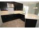 Beautiful kitchen with dark cabinetry, stainless steel range hood, and quartz counters at 843 Steel Dr, Apollo Beach, FL 33572
