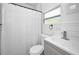 Cozy bathroom with white shower curtain and tiled floor at 847 Highland N St, St Petersburg, FL 33701
