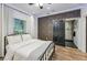 Stylish bedroom featuring a decorative wall, wood floors, and a sliding door to the bathroom at 847 Highland N St, St Petersburg, FL 33701
