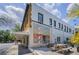 Commercial building featuring 'Uptown' wall art and a cafe with outdoor seating, blending culture and cuisine at 847 Highland N St, St Petersburg, FL 33701