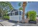 Inviting exterior featuring gray siding, white trim, palm tree and well-maintained landscaping at 847 Highland N St, St Petersburg, FL 33701