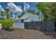 Quaint home exterior showcasing a dark fence and lush landscaping at 847 Highland N St, St Petersburg, FL 33701