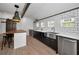 Bright kitchen featuring stainless steel appliances, modern white countertops, and a stainless steel farmhouse sink at 847 Highland N St, St Petersburg, FL 33701