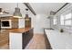 Modern kitchen with a butcher block island, stainless steel appliances, and a white subway tile backsplash at 847 Highland N St, St Petersburg, FL 33701