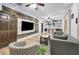 Open living room with wood accent wall, modern furniture, and seamless transition to kitchen at 847 Highland N St, St Petersburg, FL 33701
