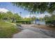 Well-maintained tennis courts with a surrounding fence, greenery, a bench, and a clear blue sky, ideal for recreation at 847 Highland N St, St Petersburg, FL 33701