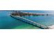 Scenic aerial view of a bridge connecting to high rise buildings on an island, with calm turquoise water around it at 855 Bayway Blvd # 703, Clearwater Beach, FL 33767
