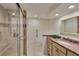 Bathroom featuring marble countertop, glass shower and vanity at 855 Bayway Blvd # 703, Clearwater Beach, FL 33767
