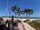 Inviting beach access with a paved walkway, palm trees, and water views at 855 Bayway Blvd # 703, Clearwater Beach, FL 33767