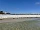 Expansive beach view, featuring clear turquoise water and pristine white sand under a clear blue sky at 855 Bayway Blvd # 703, Clearwater Beach, FL 33767