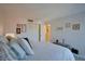 Well-lit bedroom with a queen-sized bed and a view to the entry hallway at 855 Bayway Blvd # 703, Clearwater Beach, FL 33767