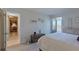 A bright bedroom boasts white decor, a water view, and a queen bed with a soft duvet at 855 Bayway Blvd # 703, Clearwater Beach, FL 33767