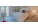 A serene bedroom with white furnishings, a queen bed, and a balcony with a view at 855 Bayway Blvd # 703, Clearwater Beach, FL 33767