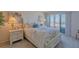 Comfortable bedroom with balcony access and scenic water view at 855 Bayway Blvd # 703, Clearwater Beach, FL 33767