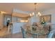 Cozy dining area next to a kitchen featuring pendant lighting, a glass top table, and elegant chairs at 855 Bayway Blvd # 703, Clearwater Beach, FL 33767