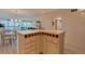An open-concept kitchen and dining area with pendant lighting, white cabinetry, and a center island at 855 Bayway Blvd # 703, Clearwater Beach, FL 33767