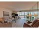 Cozy living room features scenic water views, comfortable seating, large windows, and a mirrored wall at 855 Bayway Blvd # 703, Clearwater Beach, FL 33767