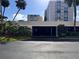 View of the parking garage entrance with lush landscaping surrounding it at 855 Bayway Blvd # 703, Clearwater Beach, FL 33767