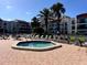 Relaxing hot tub area with lounge chairs surrounded by beautiful condo buildings and tropical palm trees at 855 Bayway Blvd # 703, Clearwater Beach, FL 33767