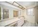 Bathroom with a vanity, large mirror, and a shower/tub combination at 9413 Stonewall Ln, New Port Richey, FL 34655