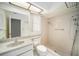 Tiled bathroom features a walk-in shower, toilet, and vanity sink at 9413 Stonewall Ln, New Port Richey, FL 34655