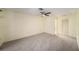 Comfortable carpeted bedroom featuring a ceiling fan and closet space at 9413 Stonewall Ln, New Port Richey, FL 34655