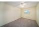 Cozy bedroom featuring neutral tones, carpet flooring, and a window with natural light at 9413 Stonewall Ln, New Port Richey, FL 34655