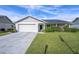 Charming single-story home featuring a two-car garage, solar panels, and well-maintained lawn at 9413 Stonewall Ln, New Port Richey, FL 34655