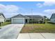Attractive one-story home with a garage, solar panels, and a well-kept front lawn at 9413 Stonewall Ln, New Port Richey, FL 34655