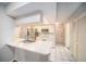 Bright kitchen features white cabinetry, stainless steel appliances, and a convenient breakfast bar at 9413 Stonewall Ln, New Port Richey, FL 34655