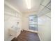 Functional laundry room offers ample storage with shelving and a utility sink at 9413 Stonewall Ln, New Port Richey, FL 34655