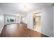Open-concept living space featuring hardwood floors and views of the kitchen with stainless steel appliances at 9413 Stonewall Ln, New Port Richey, FL 34655