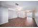 Bright and airy living room featuring wood-look floors, ceiling fan, and sliding doors at 9413 Stonewall Ln, New Port Richey, FL 34655