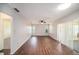 Bright living room featuring new floors and a sliding glass door that brings in lots of light at 9413 Stonewall Ln, New Port Richey, FL 34655