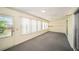 Bright sunroom with lots of windows and carpet flooring at 9413 Stonewall Ln, New Port Richey, FL 34655