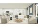 Bright living room with modern furniture, a contemporary kitchen, and a neutral color palette at 10210 Purple Leaf Ct, Riverview, FL 33578