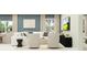 Modern living area with neutral furniture, contemporary artwork, and modern decor at 10210 Purple Leaf Ct, Riverview, FL 33578