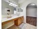 Bathroom with large mirror, vanity, and arched doorway at 10409 Fly Fishing St, Riverview, FL 33569