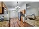 Charming kitchen featuring granite counters, stainless appliances, and wood cabinets at 10409 Fly Fishing St, Riverview, FL 33569