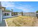Spacious fenced backyard with a screened lanai, providing a perfect outdoor living space at 10737 Scenic Dr, Port Richey, FL 34668