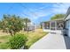 A well-maintained backyard features a screened-in lanai area perfect for outdoor entertaining at 10737 Scenic Dr, Port Richey, FL 34668