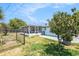 Large backyard features mature trees and a screened-in lanai, perfect for relaxation at 10737 Scenic Dr, Port Richey, FL 34668