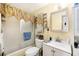 Bathroom featuring a vanity, toilet, and shower with sliding glass door, as well as patterned window and mirror trim at 10737 Scenic Dr, Port Richey, FL 34668