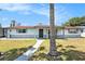 Charming single-story home featuring a covered porch and a well-maintained front yard at 10737 Scenic Dr, Port Richey, FL 34668