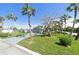 Beautiful one-story home with a well-manicured lawn and palm trees, adding curb appeal at 10737 Scenic Dr, Port Richey, FL 34668